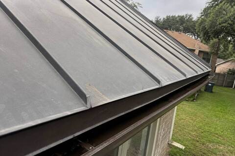 Standing seam metal panels meeting at a roof edge