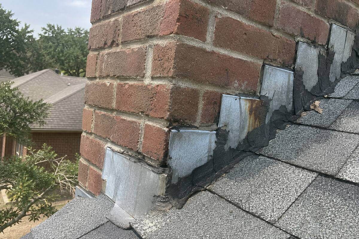 Metal flashing where a chimney meets the shingles, sealant along the joint