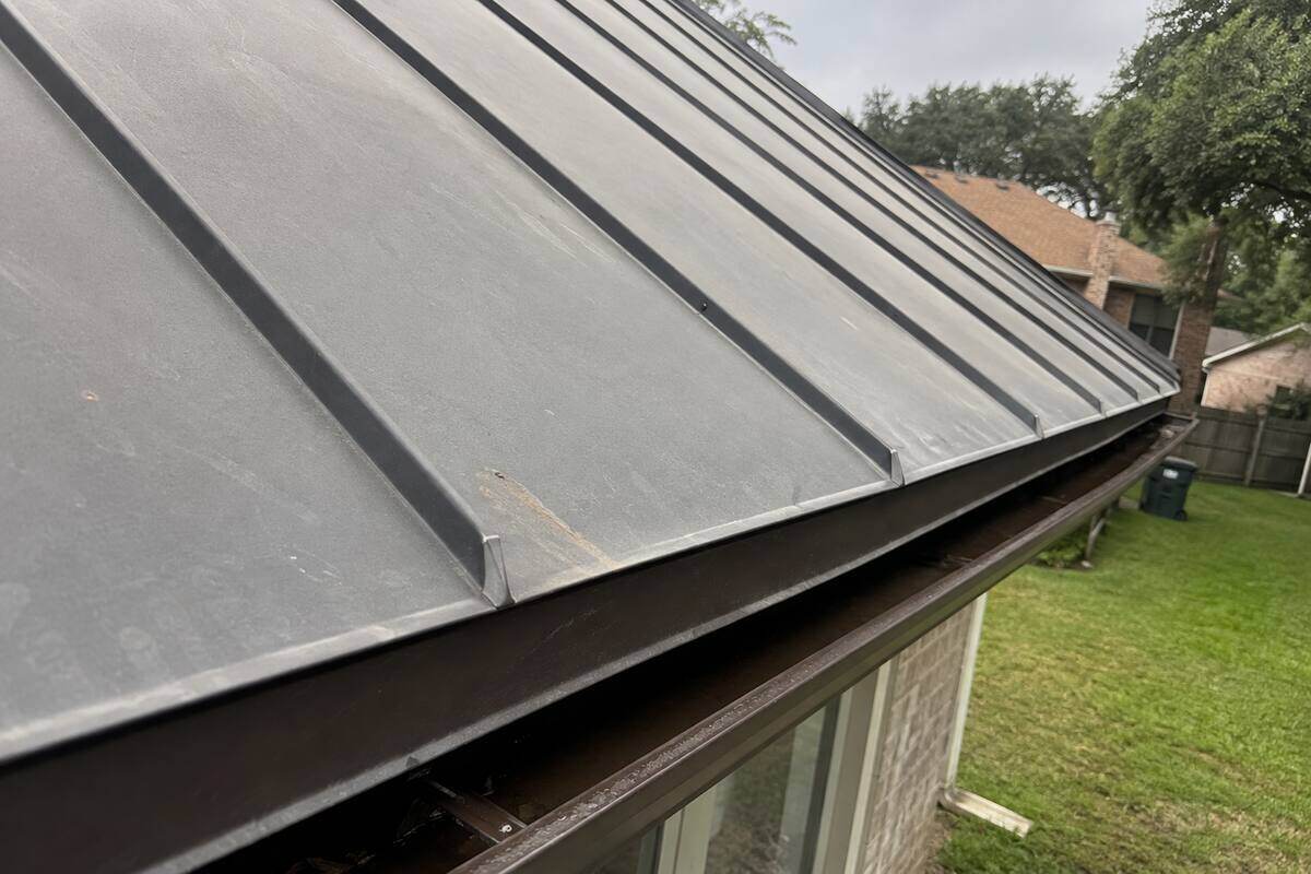Standing seam metal panels meeting at a roof edge